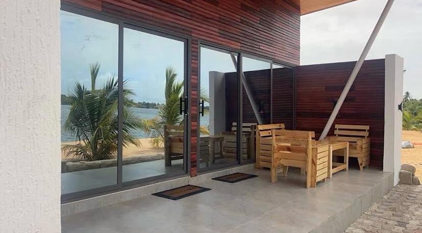 Waterfront patio with wooden benches and estuary view