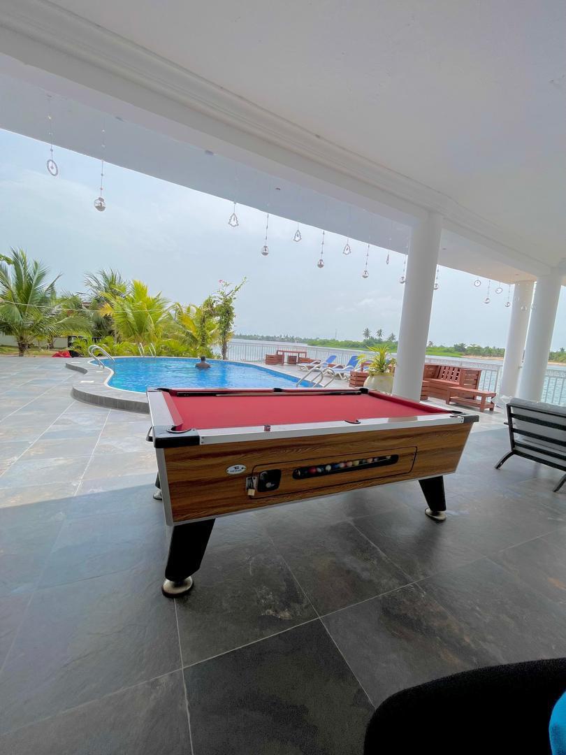 Poolside lounge with billiards table and estuary view